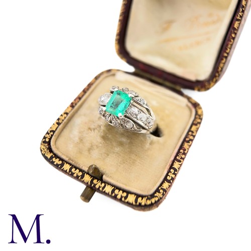 60 - An Emerald and Diamond Ring
The 18ct white gold ring is set with a bright green emerald cut emerald ... 