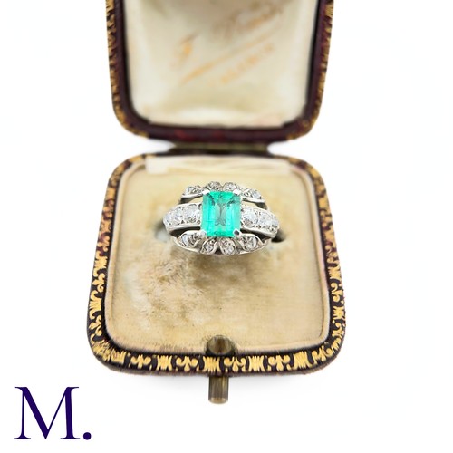 18 - An Emerald and Diamond Ring
The 18ct white gold ring is set with a bright green emerald cut emerald ... 