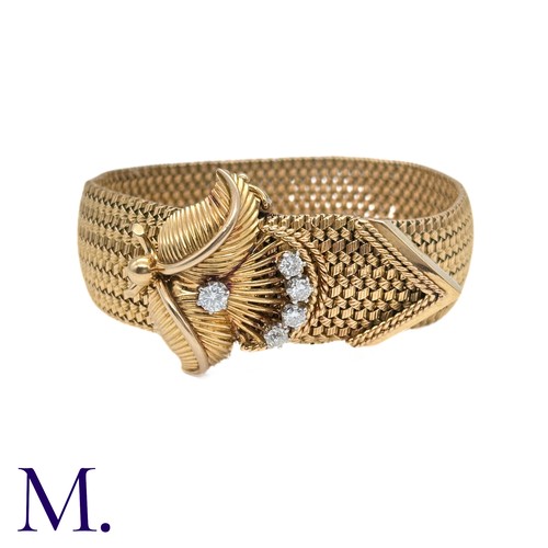 66 - A French Gold and Diamond Buckle Bracelet

The 18ct yellow gold woven bracelet terminates in a diamo... 