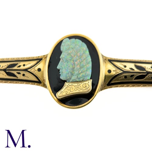 72 - A Carved Opal and Enamel Brooch

The unusual antique gold brooch is set with an impressive carved op... 