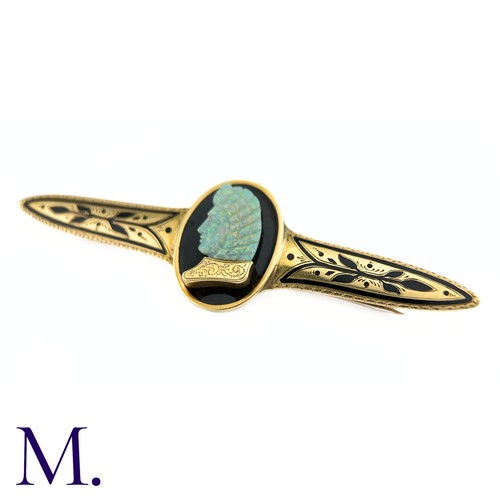 72 - A Carved Opal and Enamel Brooch

The unusual antique gold brooch is set with an impressive carved op... 