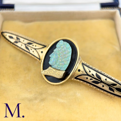 72 - A Carved Opal and Enamel Brooch

The unusual antique gold brooch is set with an impressive carved op... 