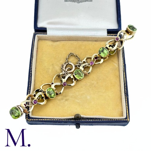 73 - A Suffragette Bracelet

The 15ct gold bracelet is set with peridot and garnet in the suffragette col... 