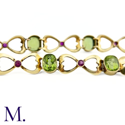 73 - A Suffragette Bracelet

The 15ct gold bracelet is set with peridot and garnet in the suffragette col... 