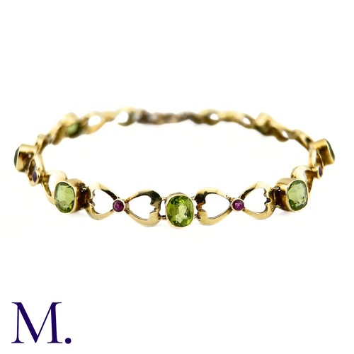 73 - A Suffragette Bracelet

The 15ct gold bracelet is set with peridot and garnet in the suffragette col... 