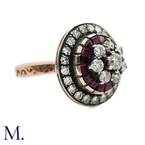 76 - An Antique Ruby and Diamond Cluster Ring.

The antique ruby and diamond ring is set with a cluster o... 