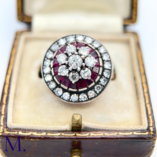 76 - An Antique Ruby and Diamond Cluster Ring.

The antique ruby and diamond ring is set with a cluster o... 