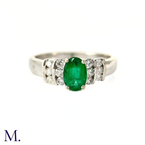 44 - An Emerald and Diamond Ring

The 18ct white gold ring is set with an oval-cut emerald of approximate... 