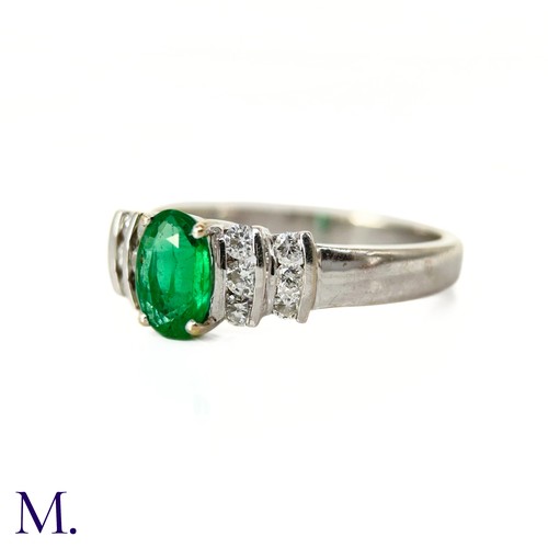 44 - An Emerald and Diamond Ring

The 18ct white gold ring is set with an oval-cut emerald of approximate... 