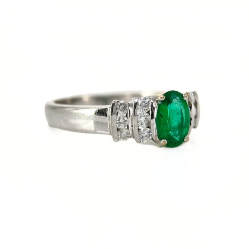 44 - An Emerald and Diamond Ring

The 18ct white gold ring is set with an oval-cut emerald of approximate... 