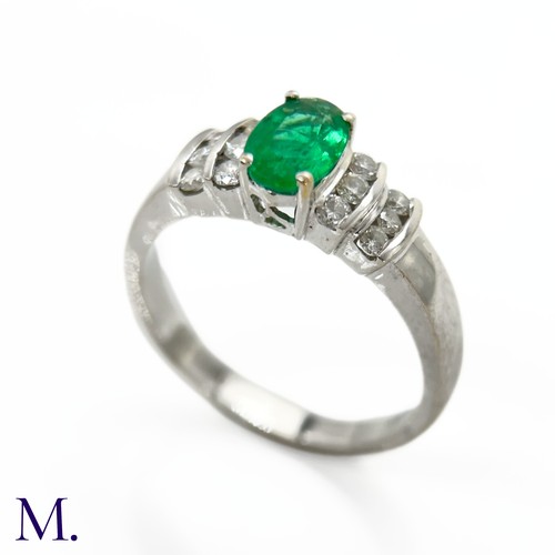 44 - An Emerald and Diamond Ring

The 18ct white gold ring is set with an oval-cut emerald of approximate... 