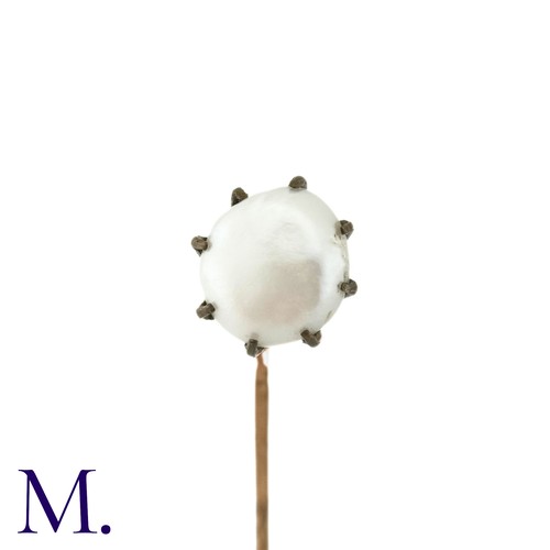 85 - An Antique Pearl Stick Pin, in yellow metal, the terminal set with a pearl of approximately 9mm. 

S... 