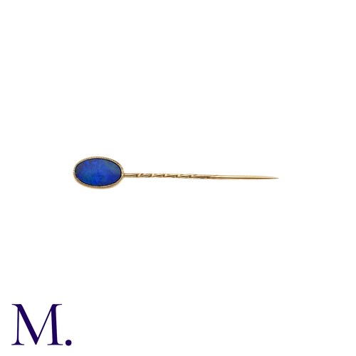 12 - An Opal Doublet Stick Pin, in yellow gold, the terminal set with a opal doublet of approximately 11m... 