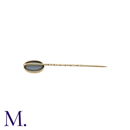 12 - An Opal Doublet Stick Pin, in yellow gold, the terminal set with a opal doublet of approximately 11m... 