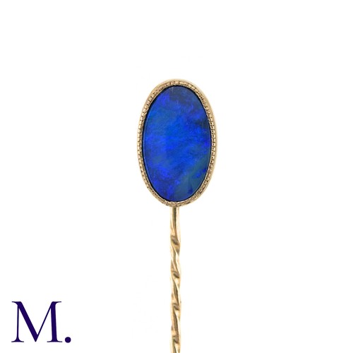 12 - An Opal Doublet Stick Pin, in yellow gold, the terminal set with a opal doublet of approximately 11m... 