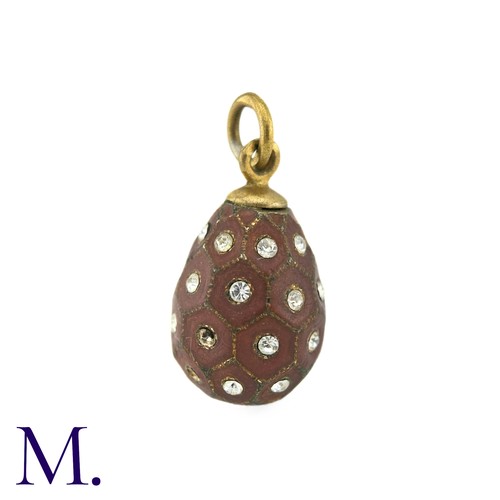 31 - An Enamelled Egg Pendant, with brown enamel, set with white paste stones. Marks indistinct.

Size: 2... 