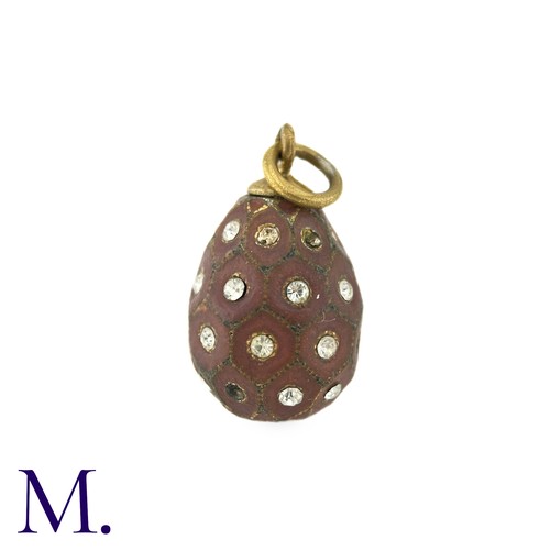 31 - An Enamelled Egg Pendant, with brown enamel, set with white paste stones. Marks indistinct.

Size: 2... 