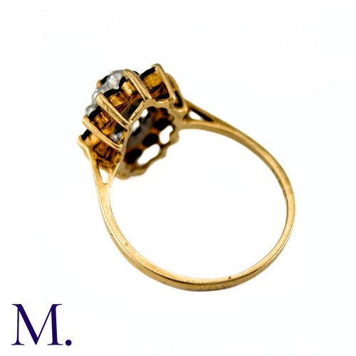 9 - A Sapphire and Diamond Ring in 9k yellow gold, the central marquise cut sapphire surrounded by a bor... 