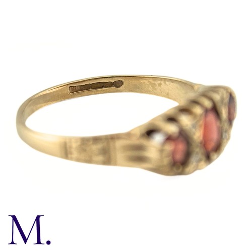 7 - A Garnet and Diamond Ring, in 9k yellow gold, the three oval cut Garnets punctuated by pairs of roun... 