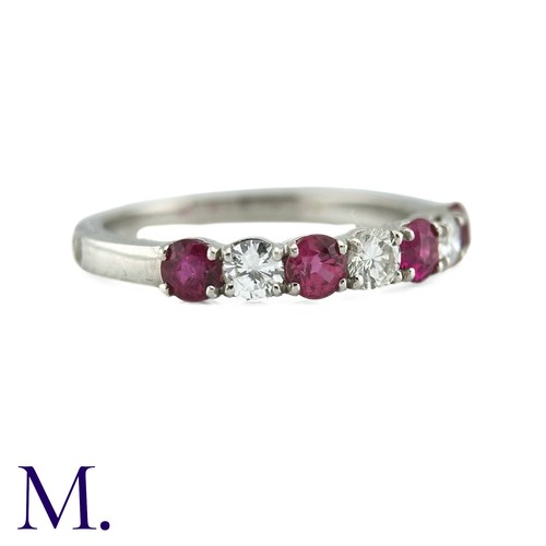 34 - A Ruby And Diamond Seven Stone Ring in platinum, set with an alternating row of four round cut rubie... 