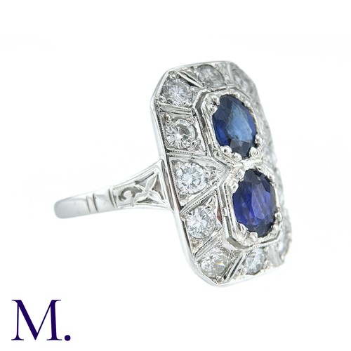 36 - An Art Deco Sapphire And Diamond Ring in 18k white gold, set with two principal cushion cut sapphire... 