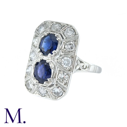 36 - An Art Deco Sapphire And Diamond Ring in 18k white gold, set with two principal cushion cut sapphire... 