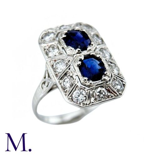 36 - An Art Deco Sapphire And Diamond Ring in 18k white gold, set with two principal cushion cut sapphire... 