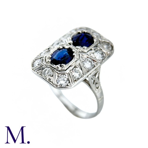 36 - An Art Deco Sapphire And Diamond Ring in 18k white gold, set with two principal cushion cut sapphire... 