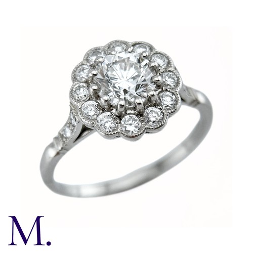 66 - A Diamond Cluster Ring in platinum, the principal claw set round brilliant cut diamond of approximat... 