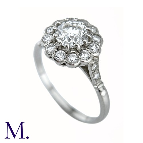 66 - A Diamond Cluster Ring in platinum, the principal claw set round brilliant cut diamond of approximat... 