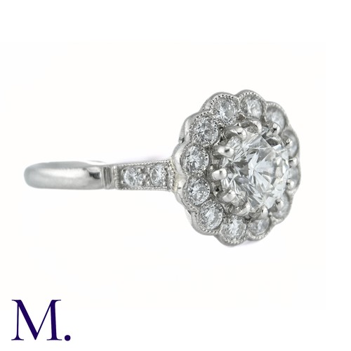 66 - A Diamond Cluster Ring in platinum, the principal claw set round brilliant cut diamond of approximat... 