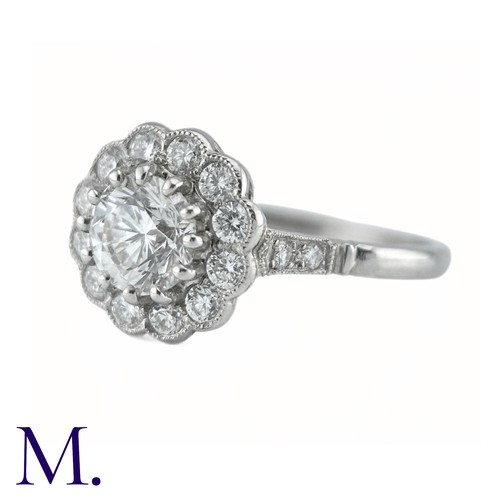 66 - A Diamond Cluster Ring in platinum, the principal claw set round brilliant cut diamond of approximat... 