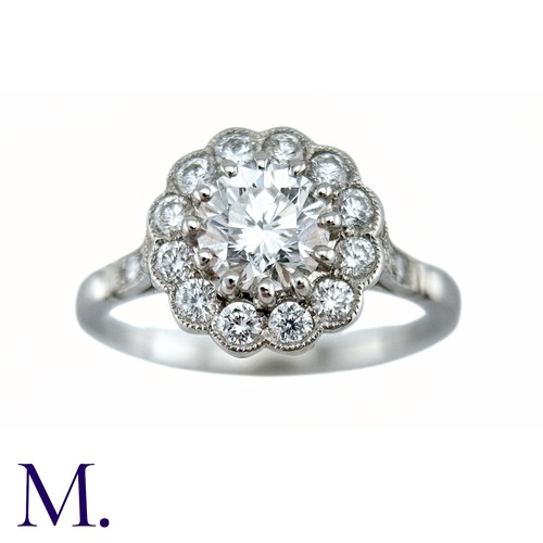 66 - A Diamond Cluster Ring in platinum, the principal claw set round brilliant cut diamond of approximat... 