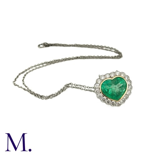 76 - An Emerald And Diamond Heart Shaped Cluster Pendant in 18k yellow gold and platinum, the principal h... 