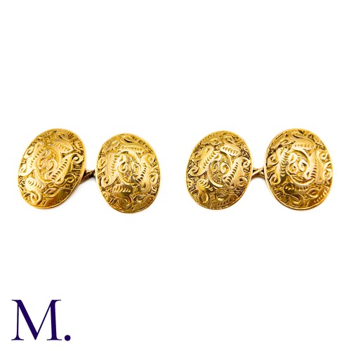 52 - A Pair Of Engraved Oval Cufflinks in 15k yellow gold,  the oval form with engraved celtic pattern de... 