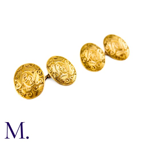 52 - A Pair Of Engraved Oval Cufflinks in 15k yellow gold,  the oval form with engraved celtic pattern de... 