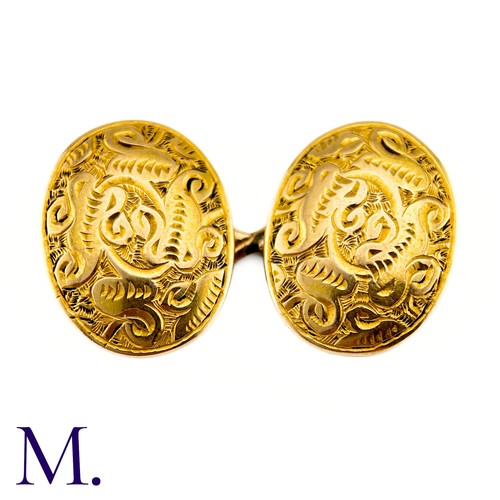 52 - A Pair Of Engraved Oval Cufflinks in 15k yellow gold,  the oval form with engraved celtic pattern de... 