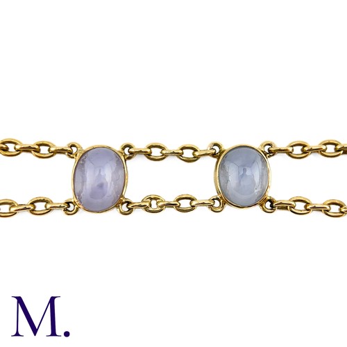 72 - A Star Sapphire Bracelet in 18k yellow gold, comprising two rows of chain set with four cabochon sta... 