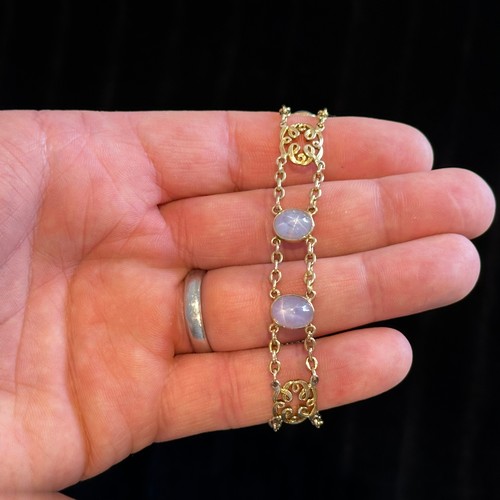 72 - A Star Sapphire Bracelet in 18k yellow gold, comprising two rows of chain set with four cabochon sta... 