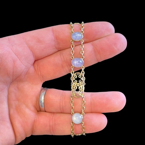 72 - A Star Sapphire Bracelet in 18k yellow gold, comprising two rows of chain set with four cabochon sta... 