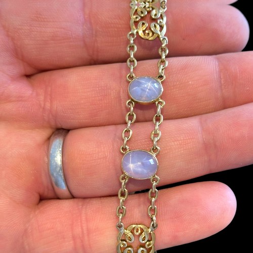 72 - A Star Sapphire Bracelet in 18k yellow gold, comprising two rows of chain set with four cabochon sta... 