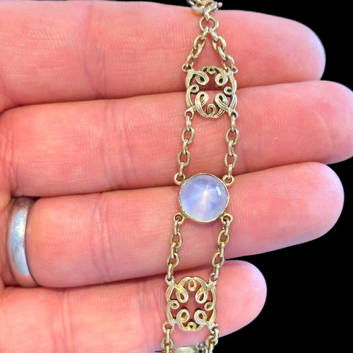 72 - A Star Sapphire Bracelet in 18k yellow gold, comprising two rows of chain set with four cabochon sta... 