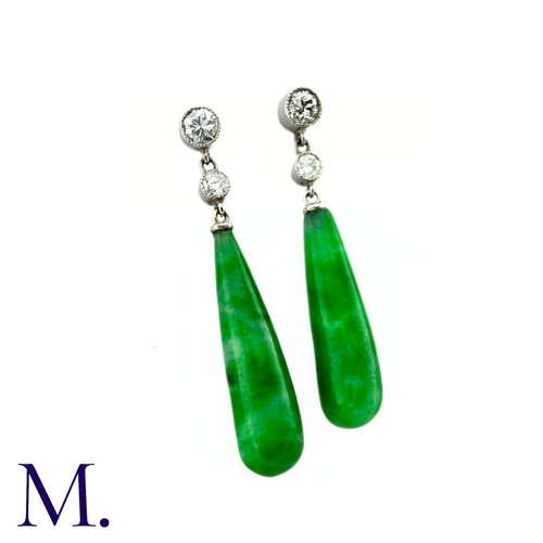 46 - A Pair of Jade Drop Earrings in platinum, two round brilliant cut diamonds suspending the polished j... 