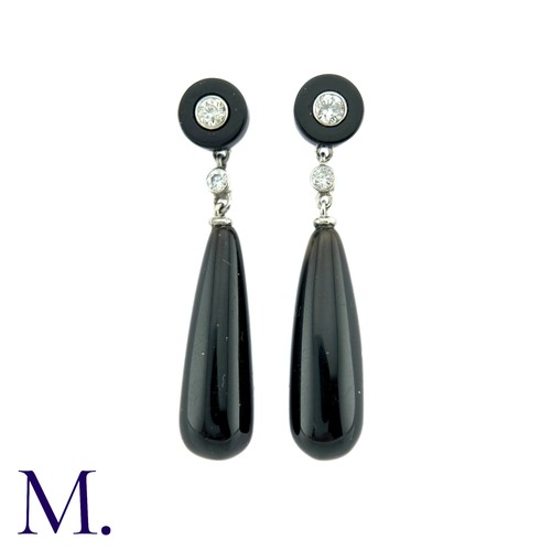 73 - A Pair Of Onyx And Diamond Drop Earrings in platinum the tops a polished onyx disc set to the centre... 