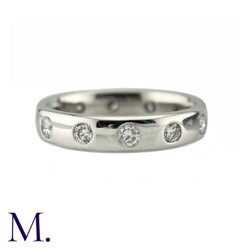 74 - A Diamond Eternity Ring in 18k white gold, the band set with twelve round brilliant cut diamonds tot... 