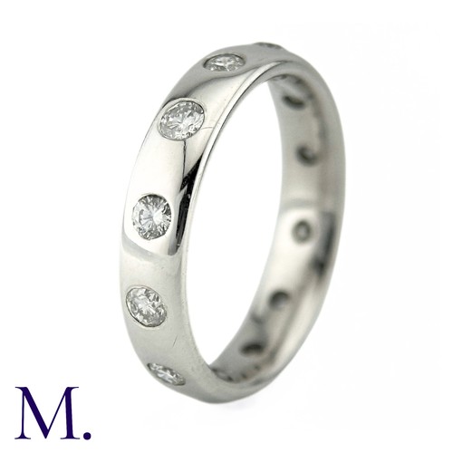 74 - A Diamond Eternity Ring in 18k white gold, the band set with twelve round brilliant cut diamonds tot... 