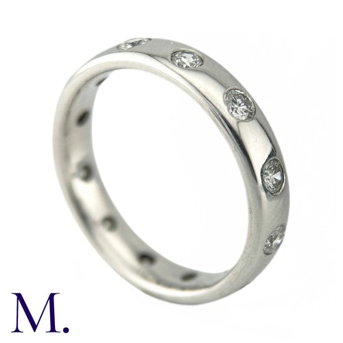 74 - A Diamond Eternity Ring in 18k white gold, the band set with twelve round brilliant cut diamonds tot... 