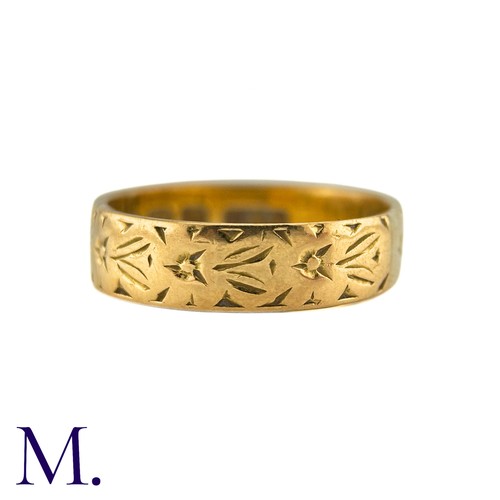 6 - A Gold Band in 22k yellow gold, the 5mm band engraved with foliate decoration. Hallmarks for 22ct go... 