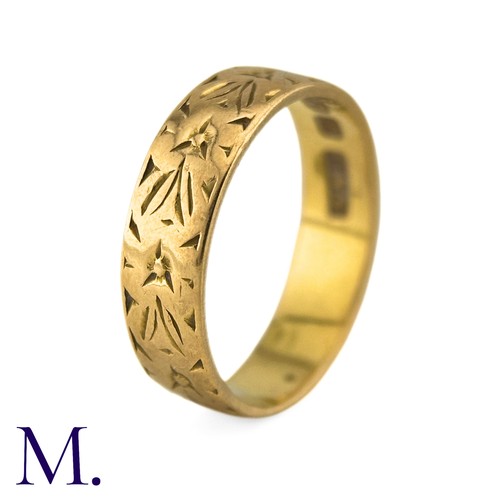 6 - A Gold Band in 22k yellow gold, the 5mm band engraved with foliate decoration. Hallmarks for 22ct go... 