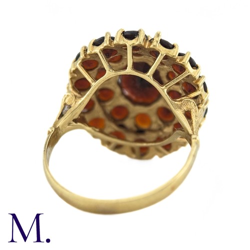 288 - NO RESERVE - A Garnet Cluster Ring in 18k yellow gold, designed as a central oval cut garnet surroun... 